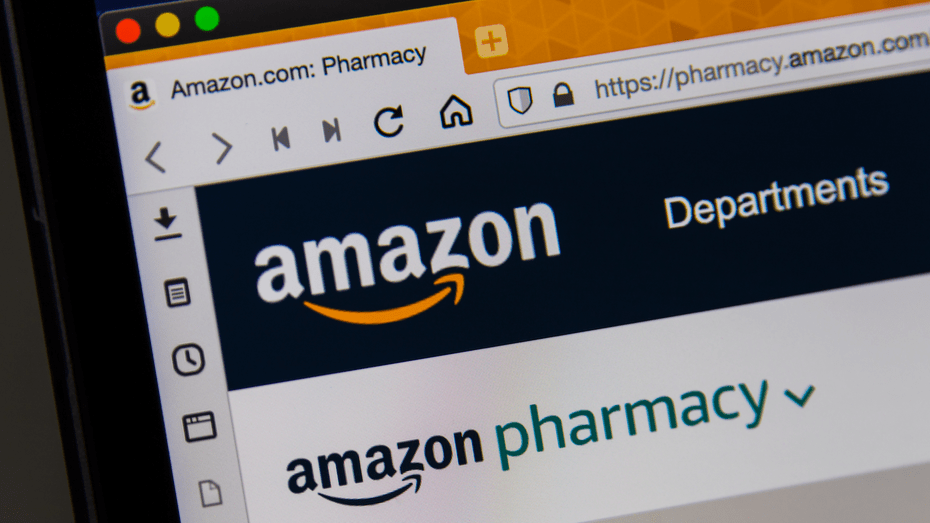 Photograph of a computer monitor showing a Chrome web browser open to the Amazon Pharmacy homepage.